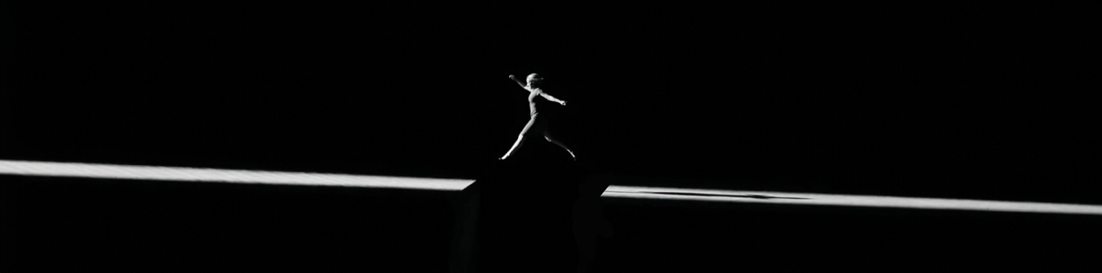 A figure leaping across light